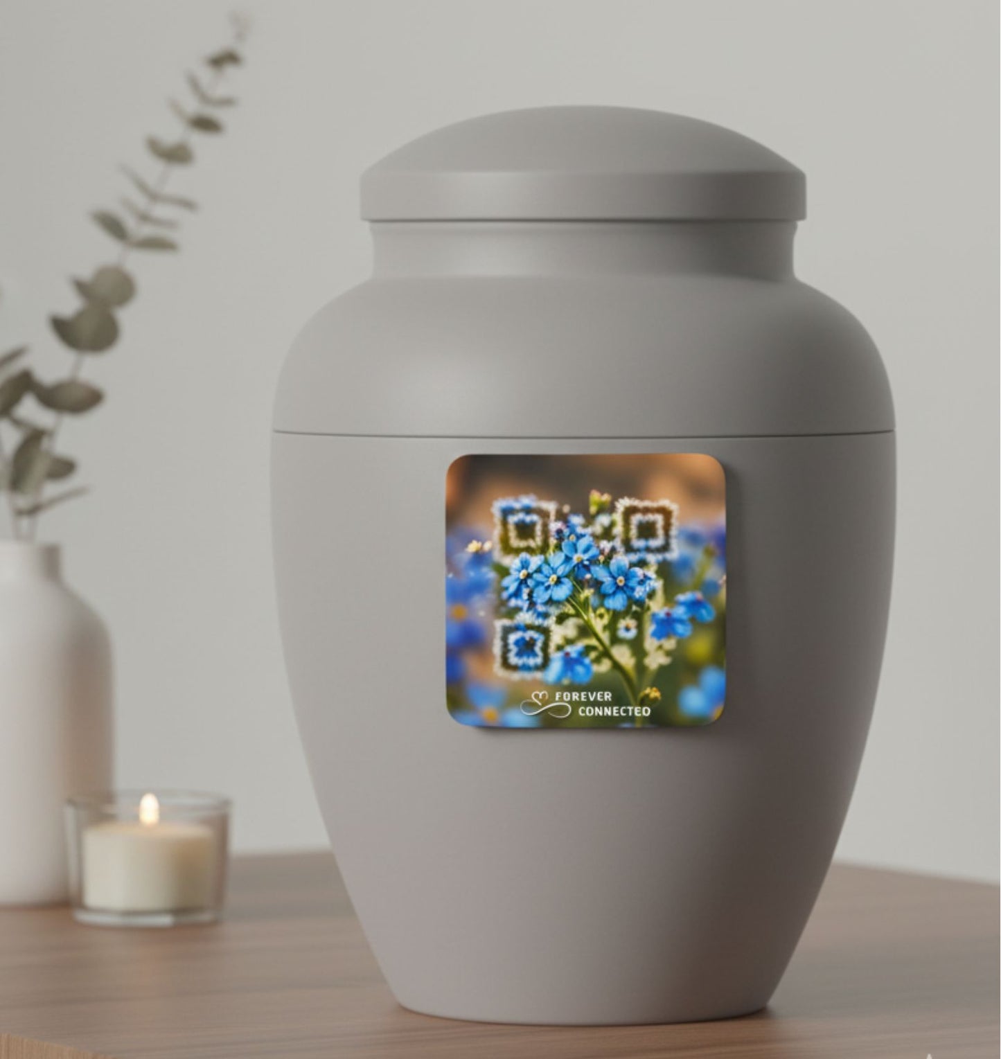 Gray urn with a digital display showing flowers and a QR code on a wooden surface.