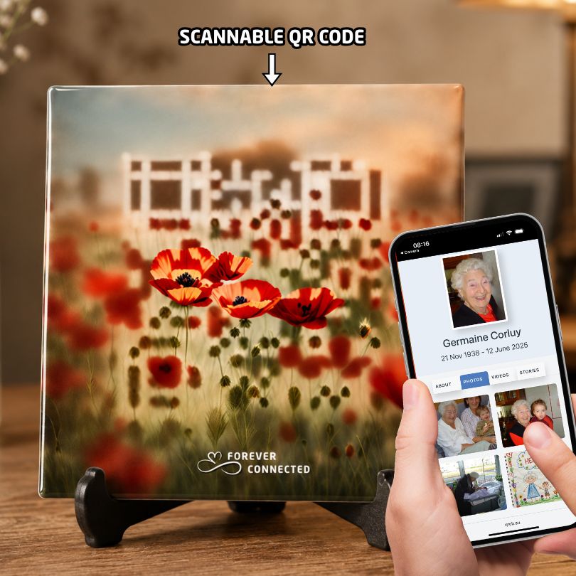 A  ceramic tile resting on a black stand, featuring red poppies with an embedded QR code that leads to a  digital memorial website.