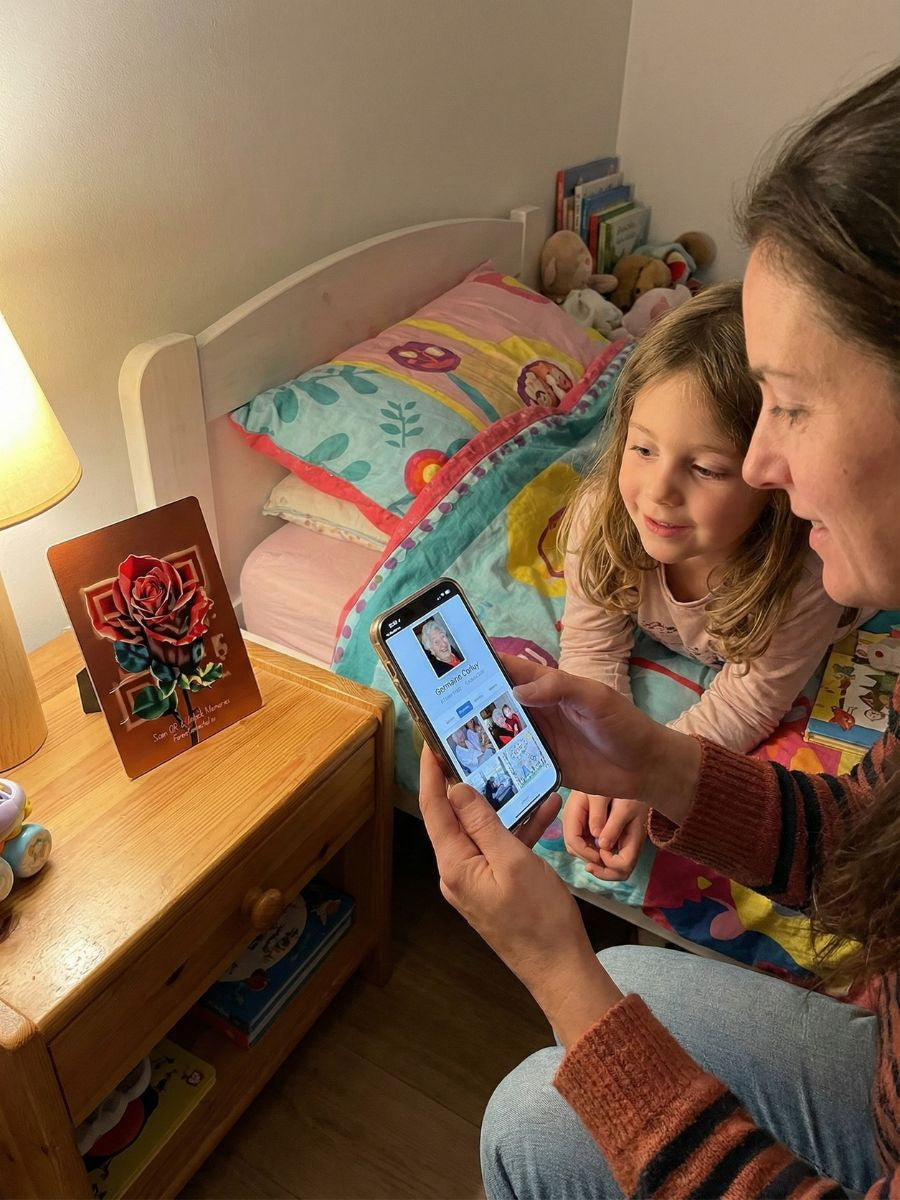 A remembrance gift for grandchildren: a Forever Connected memorial plaque with a QR Rose design, beside a child’s bed, linked to a digital memorial page with photos and memories of a loved one.