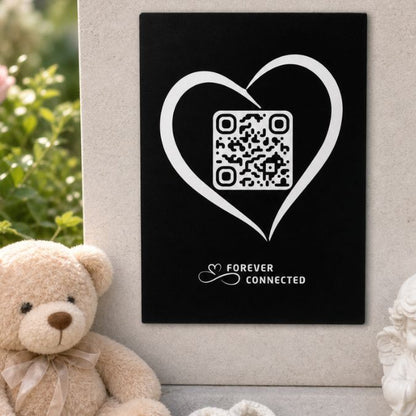 Forever Connected black plaque with heart QR remembrance plaque for an angel baby, shown with a teddy bear and linking to a digital memorial page that keeps memories alive