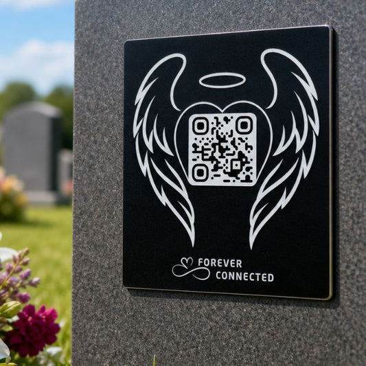 Forever Connected angel wings QR memorial plaque on a grave, linking to an online remembrance page to honour and remember a loved one.