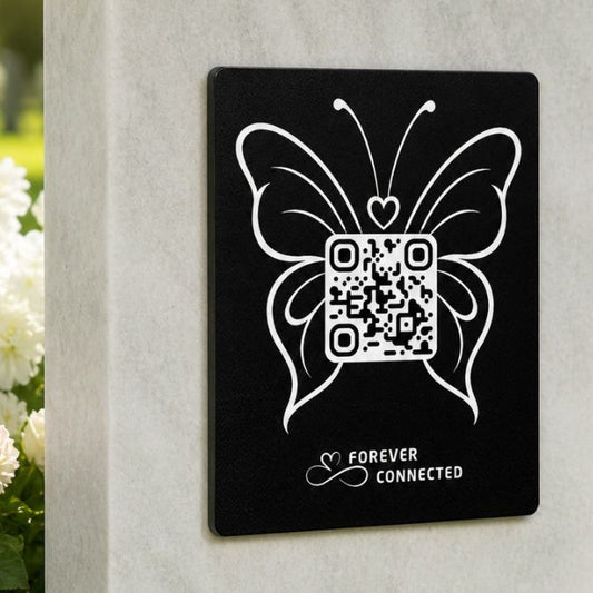 Forever Connected black plaque with  butterfly QR remembrance plaque on a light stone headstone, connecting visitors to an online tribute page with memories of a loved one