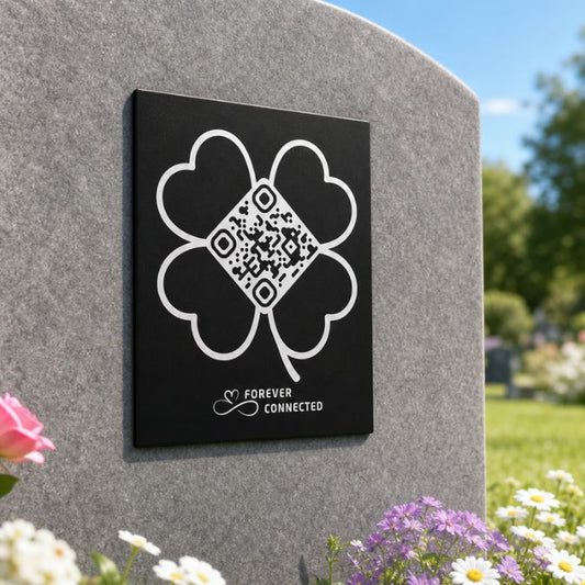 Forever Connected four-leaf clover QR memorial plaque on a grave, linking to an online tribute page to keep memories of a loved one alive.
