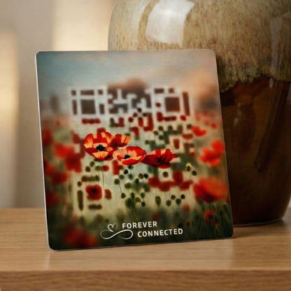 Forever Connected Red Poppies QR medallion beside an urn and framed portrait, linking to a digital memorial page for sharing memories at home.